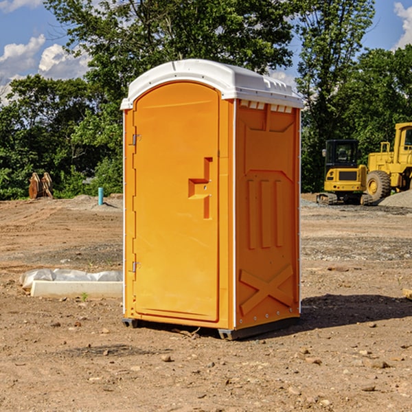 what is the cost difference between standard and deluxe portable restroom rentals in Spillville